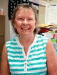 A woman in striped shirt smiling for the camera.